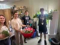 students holding vegetables